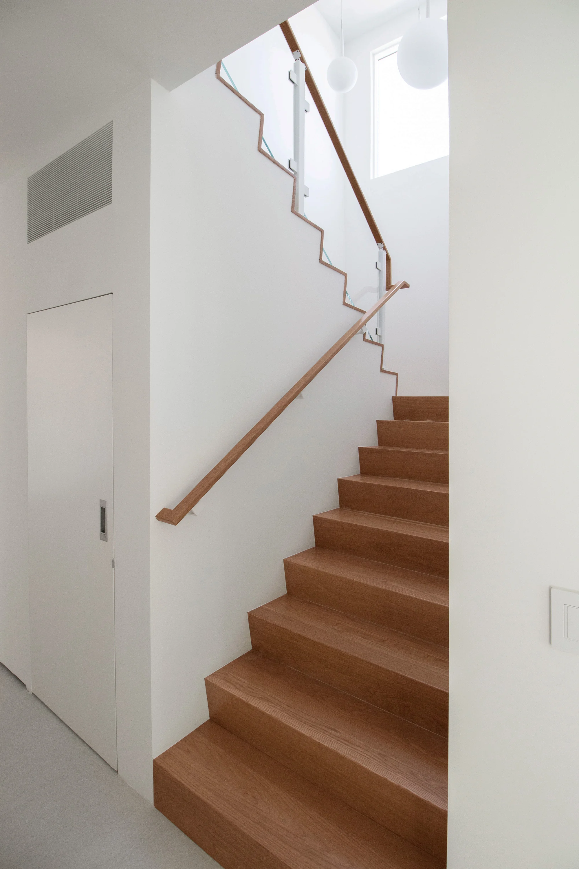 White oak staircase with restrained architectural detailing